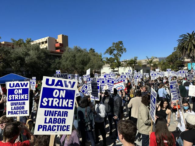 grad students holding signs