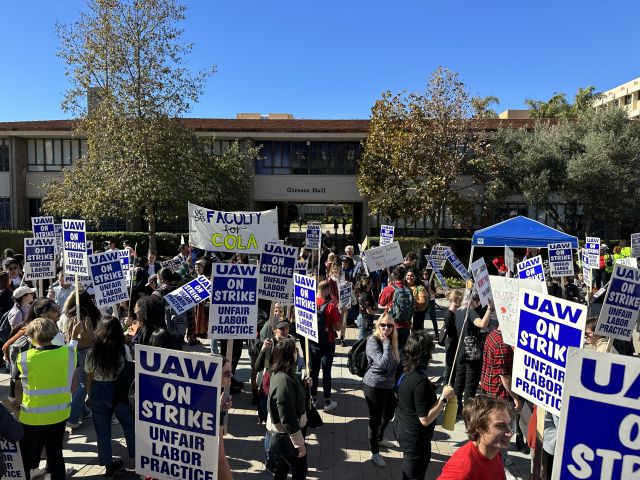 grad students holding signs